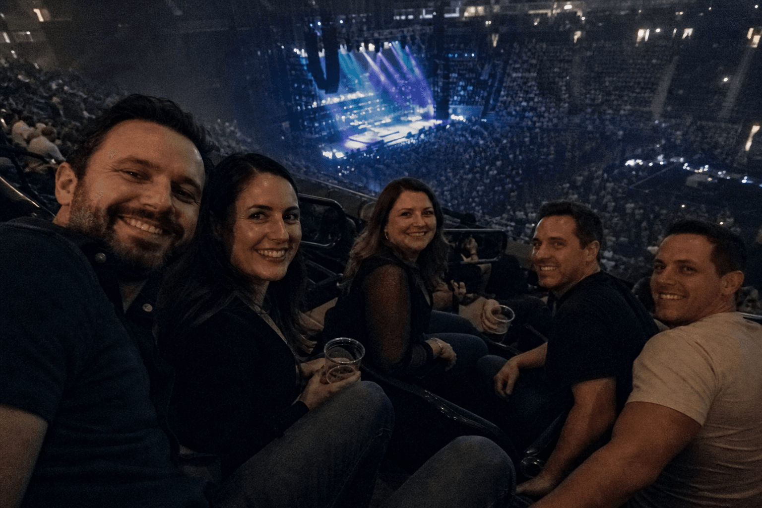 Sam and three friends taking a selfie together at a concert